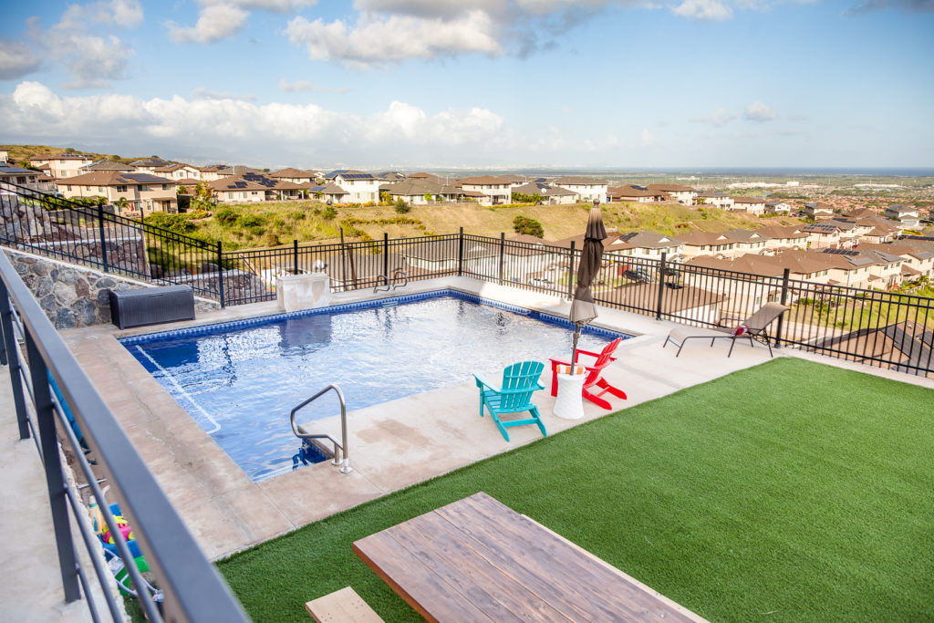 Highly upgraded exterior elements with in-ground salt-water pool, high-grade artificial turf, retain